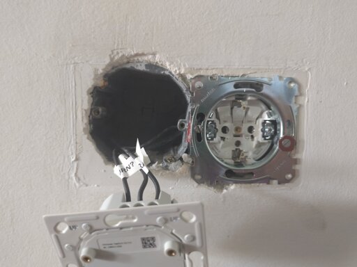 Photo of a light switch assembly hanging out of the wall in front of a very tilted electrical box.