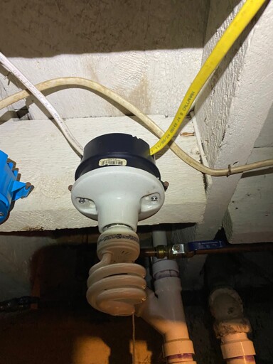 3 photos in a dingy basement. The first one shows a string pull light fixture wires with white and yellow romex cable. The second shows the next item in sequence, a similarly wired wall outlet. The third photo is of a shoddy looking lightbulb socket hung on a doorjamb with the first photos subject in the background.